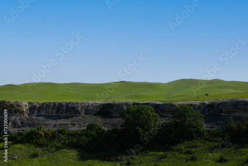 A picturesque view of the green steppe hills, pastures stretching into the distance.