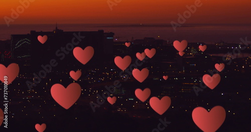 Floating hearts over a nighttime cityscape