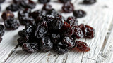 Pile of raisins sitting on top of wooden table. Suitable for food and nutrition related content