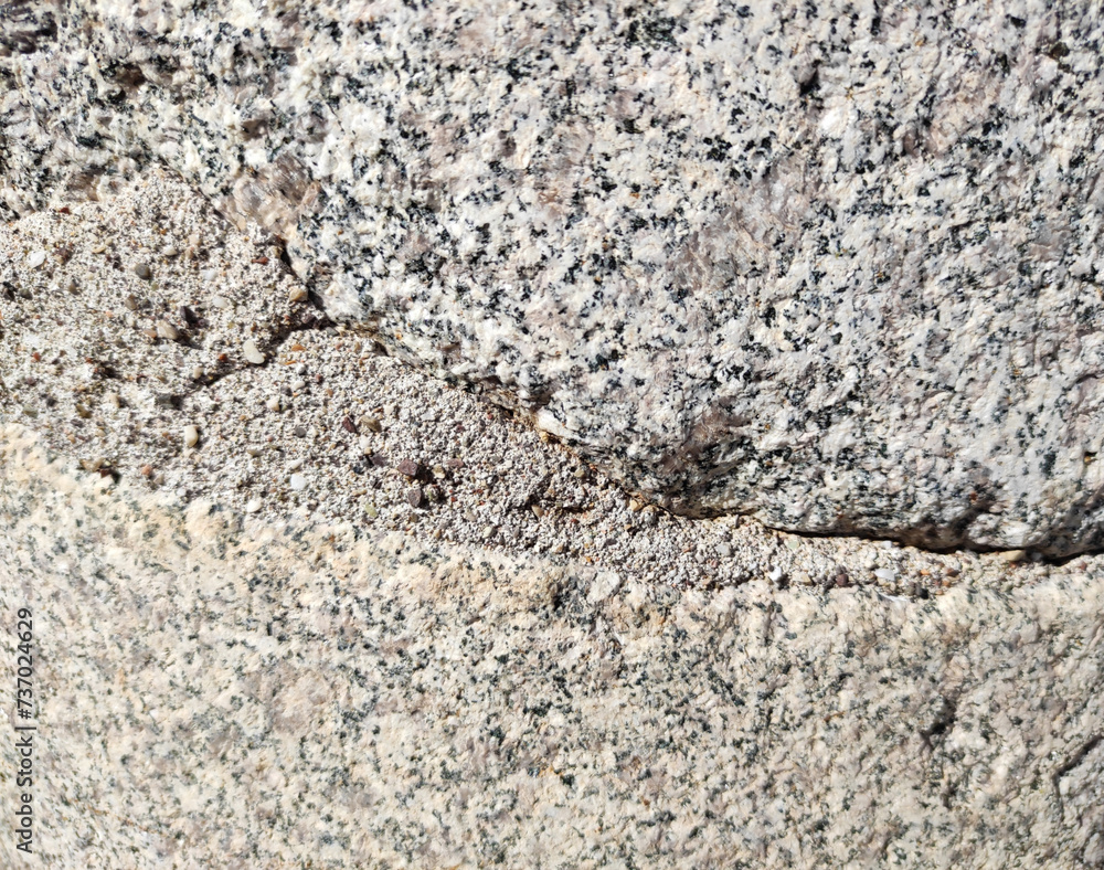 The texture of a gray marble stone with veins, cracks and inclusions The texture of a gray marble stone with veins, cracks and inclusions