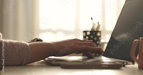 person working on laptop, close up with hands, hands typing work at home photo