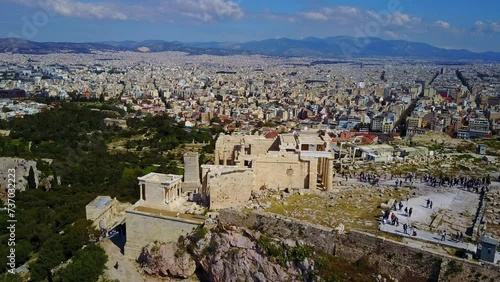 Propylaea, the Ancient principal entryway to the Acropolis of Athens, Greece. Aerial Drone Flyover with City Views. photo