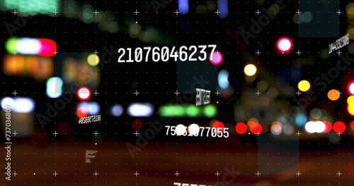 Digital composite image of multiple changing numbers against night city traffic