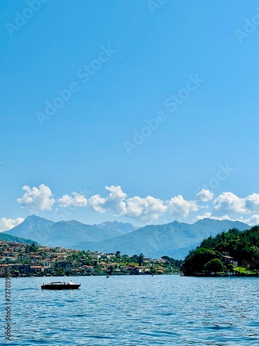 The boat in a Como lake with the landscape view of mountains © Ligita