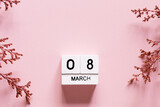 8 march wooden calendar with flowers on the pink background. Women's day composition. Copy space, top view