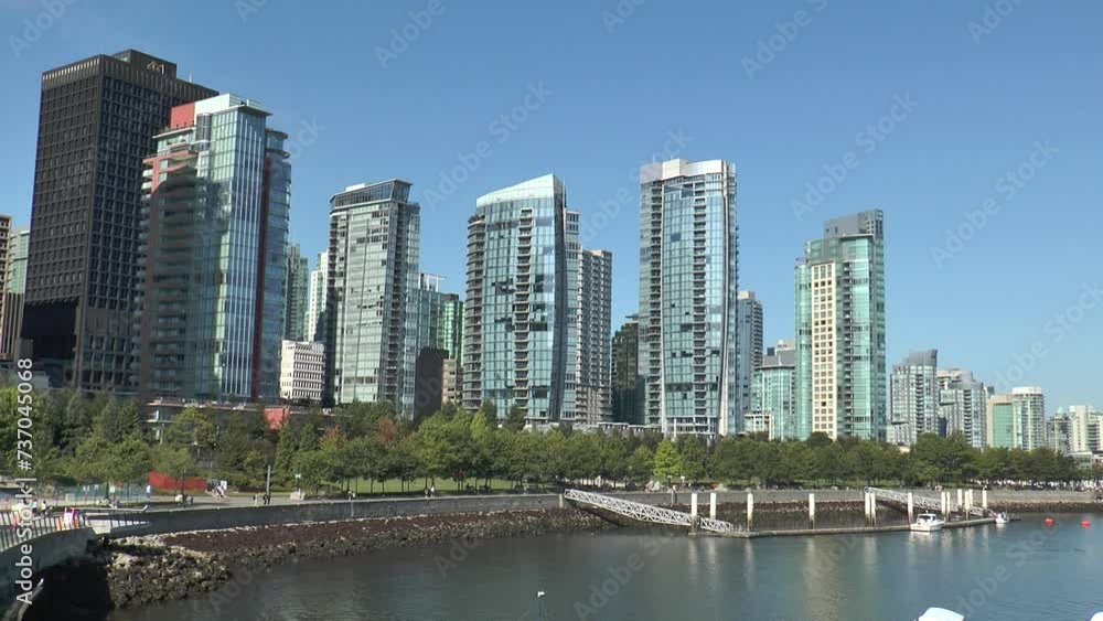 Modern residential buildings in Vancouver. Establishing shot of top of modern apartment building in Vancouver, Canada, North America. Day time. Contemporary High-Rise Buildings In The City. Modern residential buildings in Vancouver. Establishing shot of top of modern apartment building in Vancouver, Canada, North America. Day time. Contemporary High-Rise Buildings In The City.