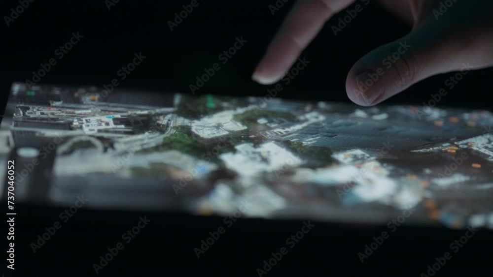 Person exploring satellite 3D view of a city map on a tablet touchscreen. Close up, slow motion. Person exploring satellite 3D view of a city map on a tablet touchscreen. Close up, slow motion.