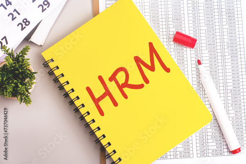 yellow notebook with toolls and notes about HRM. human resource management concept photo