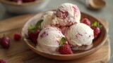 A bowl filled with three scoops of ice cream topped with fresh raspberries.