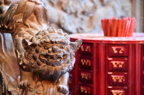 Taipei, Taiwan - January 16, 2024: The Taipei Wen Chang Temple is dedicated to the deity Wen Chang, the temple is a place of worship and learning. Left is a stone lion and fortune stick on the right. photo