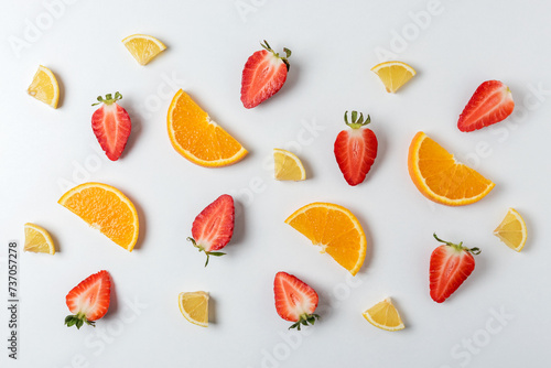 Colorful pattern made of citrus fruits and strawberries. Minimal summer concept.