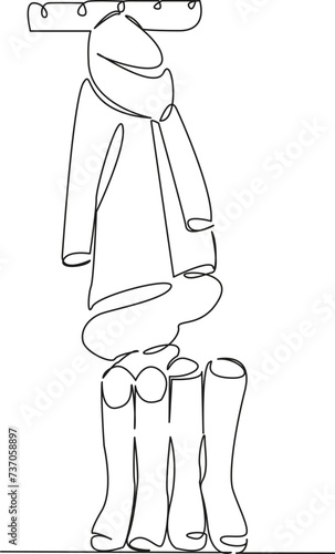 clothes are hanging on a hanger, and of boots are standing.