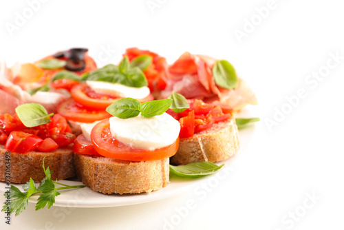 assortment of canape, bruschetta, toast with tomatoes, mozzarella and basil