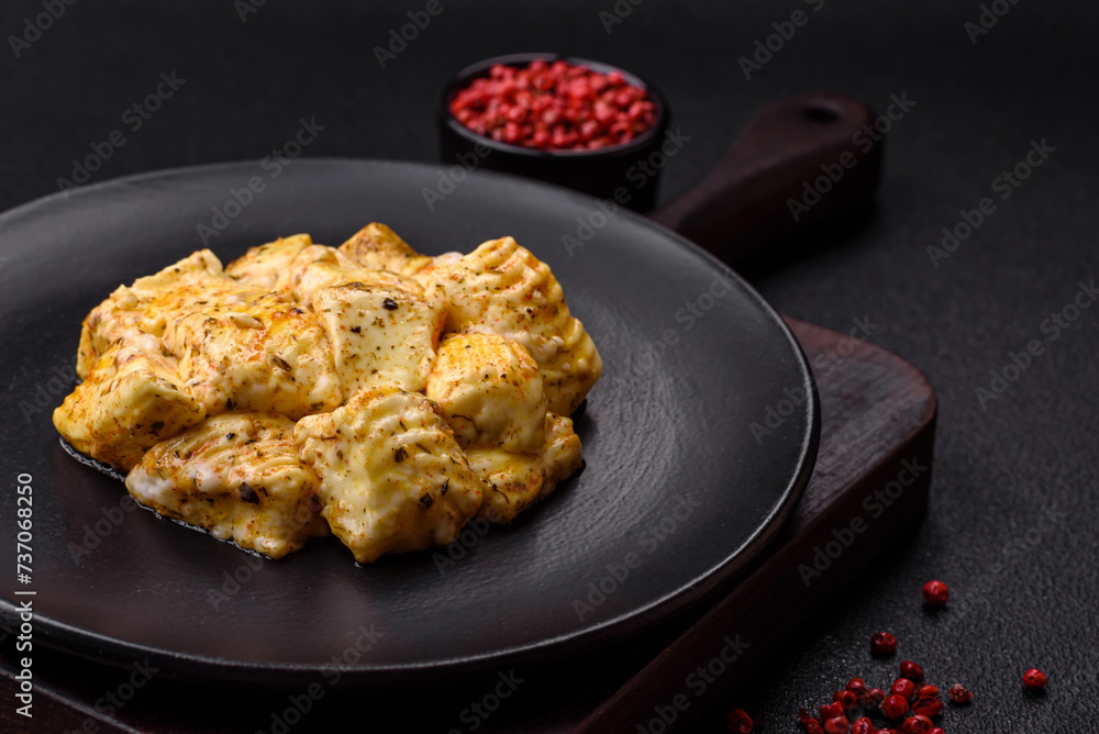 Delicious soft white feta cheese with salt, spices and herbs on a dark concrete background Delicious soft white feta cheese with salt, spices and herbs on a dark concrete background