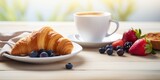 Breakfast with coffee, croissants and berries on wooden table