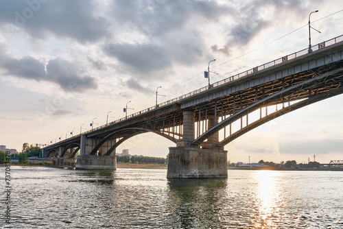 Automobile Kommunalny bridge or Oktyabrsky bridge over Ob River, Novosibirsk,Russia.Summer landscape