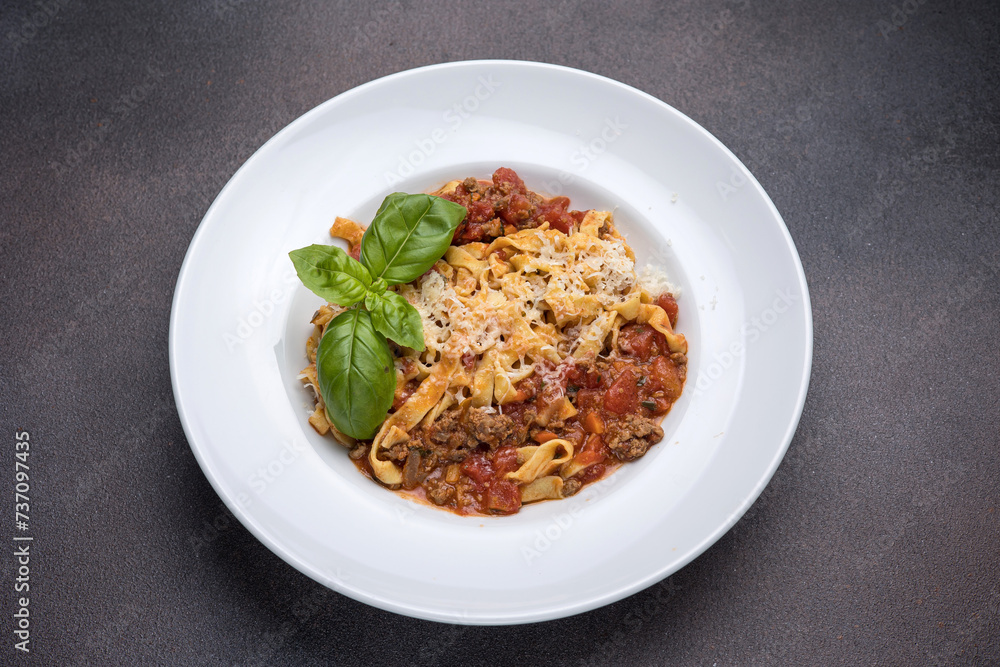 Pasta with bolognese sauce, parmesan and basil
