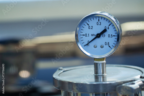metal container with pressure gauge on the lid photo