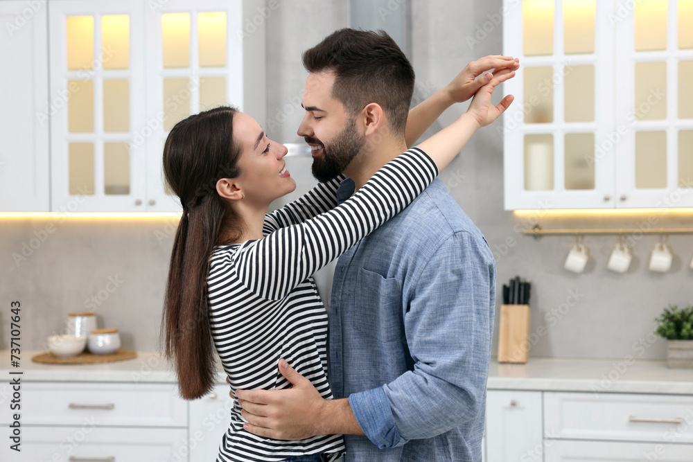 Lovely couple enjoying time together in kitchen Lovely couple enjoying time together in kitchen