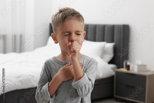 Obraz na plátně Sick boy coughing at home. Cold symptoms