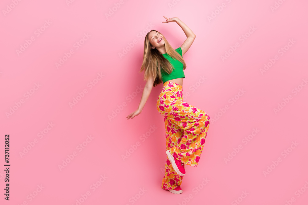 Full length photo of positive funky crazy girl dance night club good mood empty space isolated on pink color background Full length photo of positive funky crazy girl dance night club good mood empty space isolated on pink color background