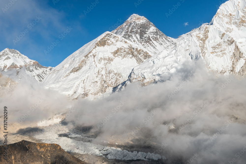View of Mount Everest, Lhotse, Nuptse and Khumbu Glacier in the clouds at sunset from Kala Pattar during Everest Base Camp trekking in Nepal. Highest mountain in the world.