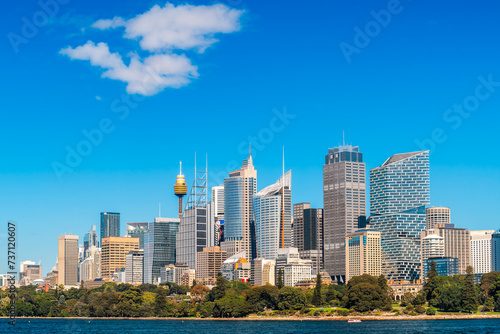 Modern Sydney City skyline with skyscrapers and office buildings viewed from ferry on bright sunny day