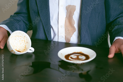 Close up spilled coffee or tea on a white shirt. daily life stain concept.