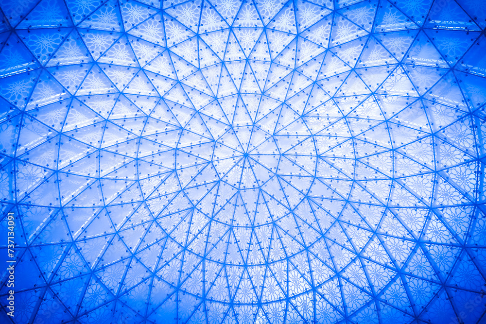 Glass ceiling in blue sky sunlight, abstract. Glass roof of the building.