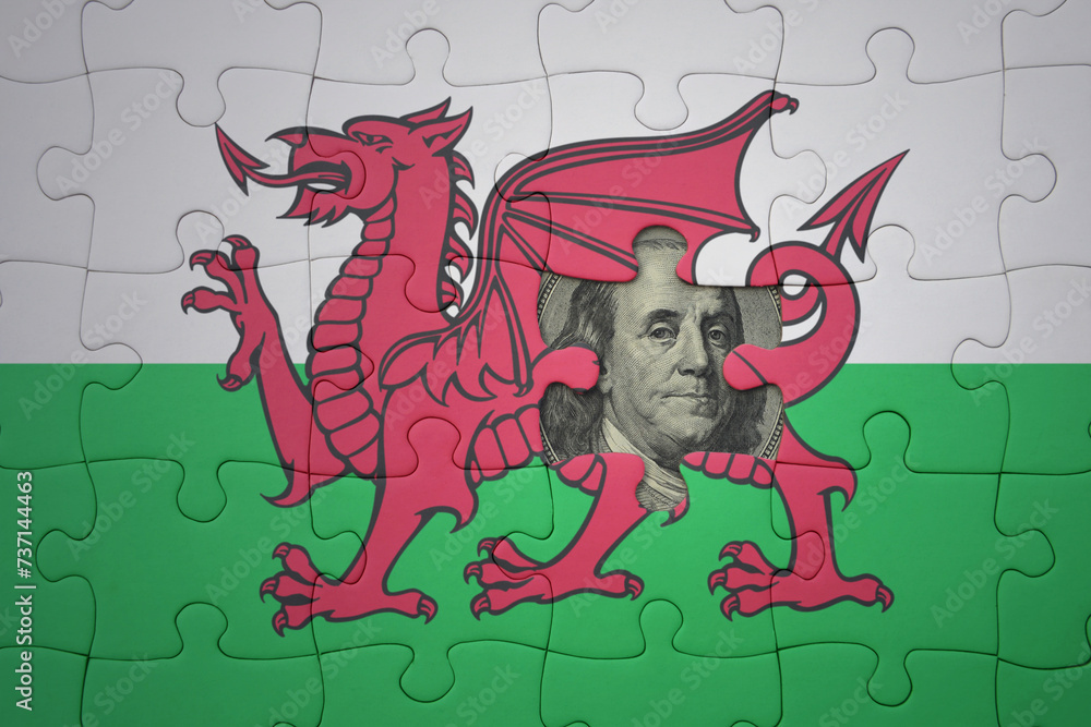 puzzle with the national flag of wales and usa dollar banknote. finance concept puzzle with the national flag of wales and usa dollar banknote. finance concept
