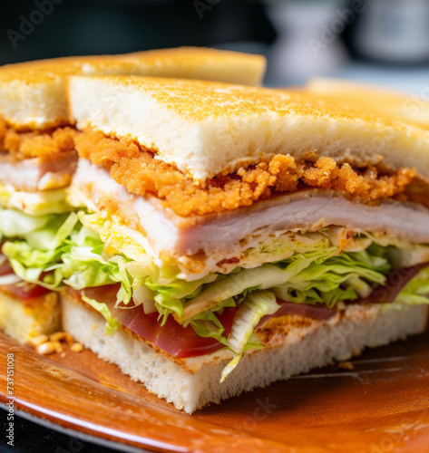 Close-up of katsu sando sandwich with chicken cutlet and cabbage on the table