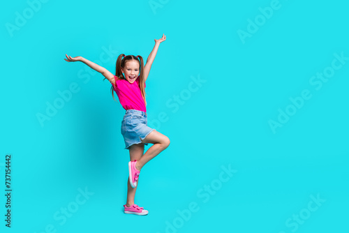 Full size profile photo of overjoyed lovely girl raise hands empty space ad isolated on teal emerald color background
