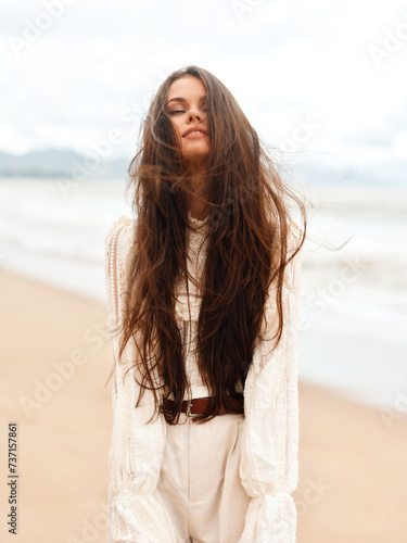 Fashionable Summer Beauty: Young, Attractive Lady in White Dress, Relaxing at the Beach, Enjoying the Sun and Ocean