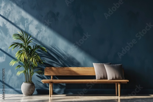 Deep blue venetian plaster painted wall background, sunny interior room with wooden bench and plant pot
