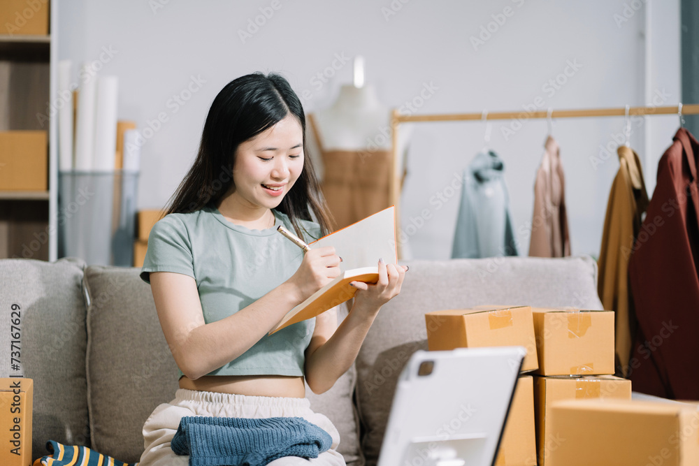 Woman start up small business owner at workplace. small business entrepreneur SME or freelance asian woman working with box at home.. Woman start up small business owner at workplace. small business entrepreneur SME or freelance asian woman working with box at home..