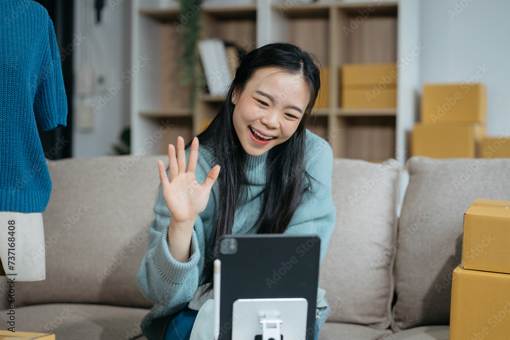 Asian vlogger woman influencer, SME retail store owner smile enjoy selling show live sale online screen smartphone and laptop work at home.. Asian vlogger woman influencer, SME retail store owner smile enjoy selling show live sale online screen smartphone and laptop work at home..