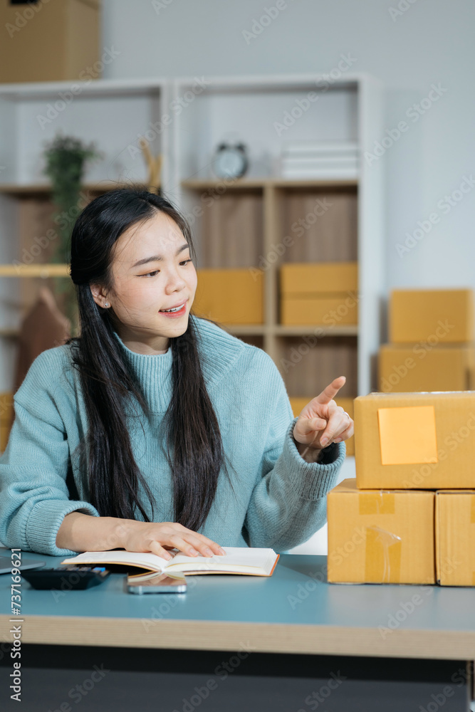 Woman start up small business owner at workplace. small business entrepreneur SME or freelance asian woman working with box at home.. Woman start up small business owner at workplace. small business entrepreneur SME or freelance asian woman working with box at home..