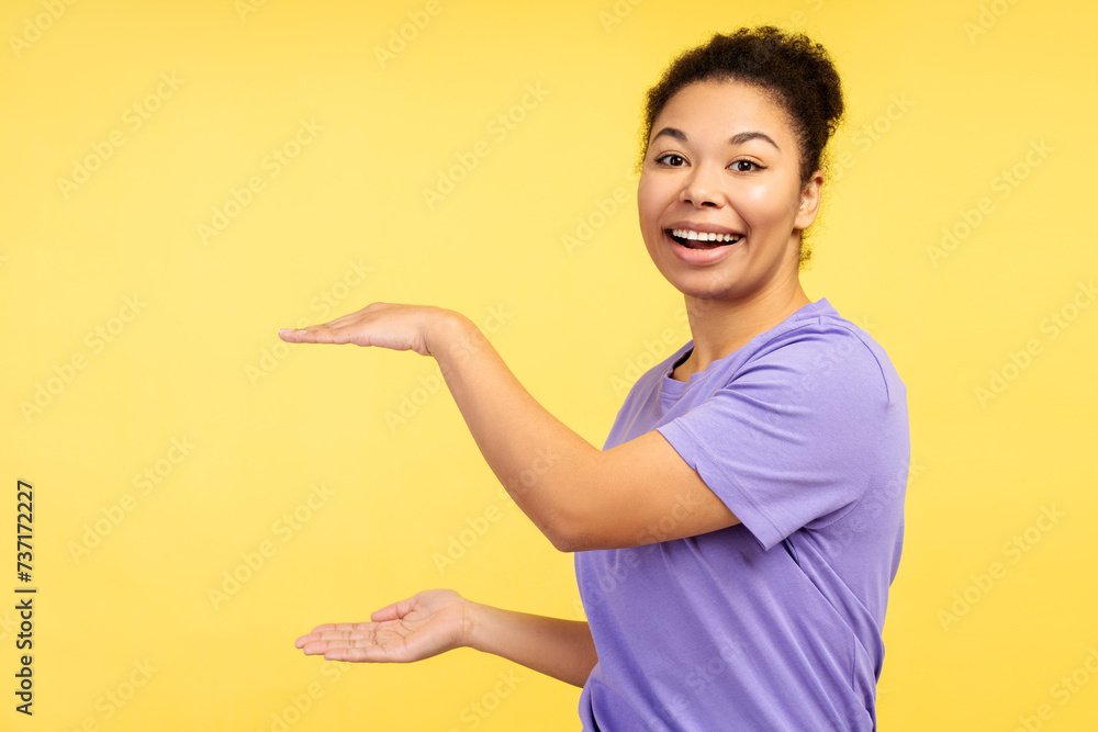 Portrait attractive, positive African American woman holding hands on copy space, looking at camera Portrait attractive, positive African American woman holding hands on copy space, looking at camera