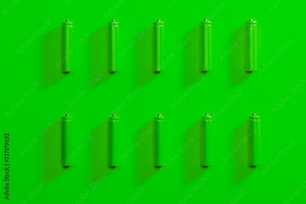Batteries Arranged on Green Background