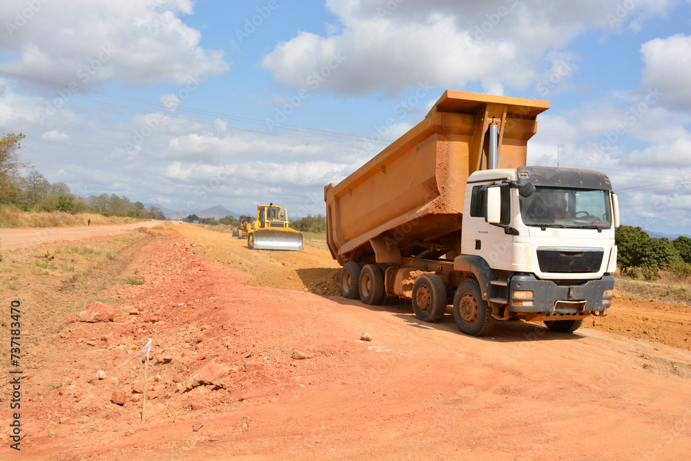 construction machines at works, dozer, roller machine, excavator, crawler rock drill machine, trucks, GPS grader