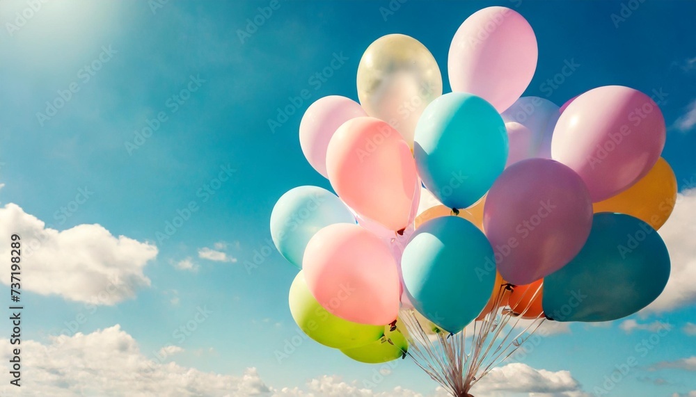 pastel colors balloons bunch in blue sunny sky background with copy space