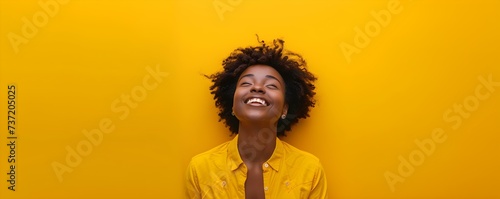 Euphoric African American woman joyfully celebrates amidst a vibrant yellow backdrop. Concept Euphoric Portraits, Vibrant Yellow Backdrop, African American Woman, Joyful Celebration