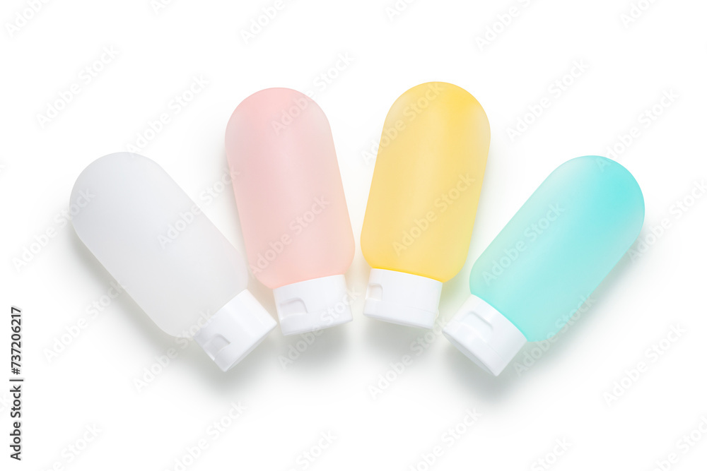 Colorful cosmetics dispensing bottles on white background