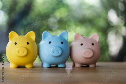 Three piggy banks sitting side by side on table. Can be used to represent savings, financial planning, or budgeting concepts.