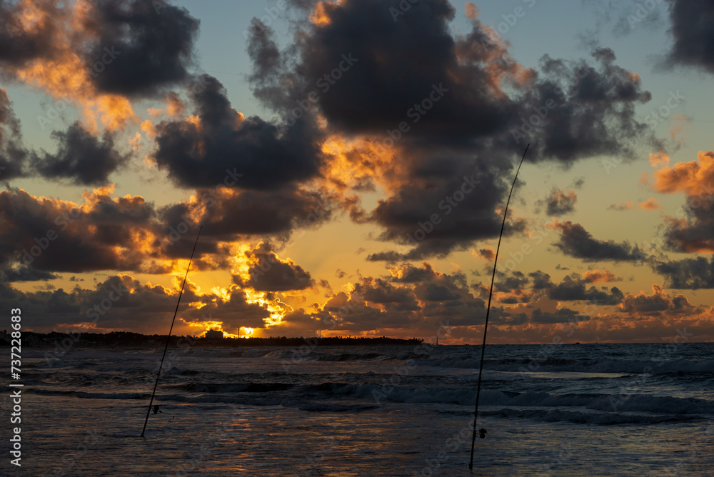 View of the day dawning with colorful clouds and the sun in yellow, orange and blue sky. Wonderful nature. View of the day dawning with colorful clouds and the sun in yellow, orange and blue sky. Wonderful nature.