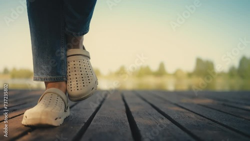Woman waiting to go to the bathroom while standing on wooden beach dock photo