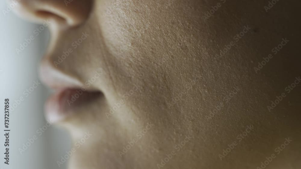 Macro shot of female model face. Asian young woman macro shot of lips and mouth, model smiling showing white teeth, side profile view. Macro shot of female model face. Asian young woman macro shot of lips and mouth, model smiling showing white teeth, side profile view.