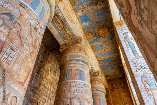 Colorful hieroglyphs carved on columns, interior of Medinet Habu temple on Luxor west bank, Egypt © Delphotostock