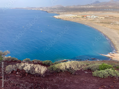 Hiking Montana Roja in El Médano, Tenerife. Red volcanic hill. View of La Tejita beach and the Atlantic photo
