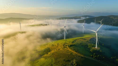 Aerial view of windturbine renewable energy farm winthwindmills on a foggy morning